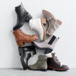 Stitch Fix women’s boots in black, brown, white, gray, green and taupe leaning against a wall.