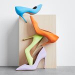 Stitch Fix women’s high heels in blue, orange, lime green and lavender in front of a wooden stand.
