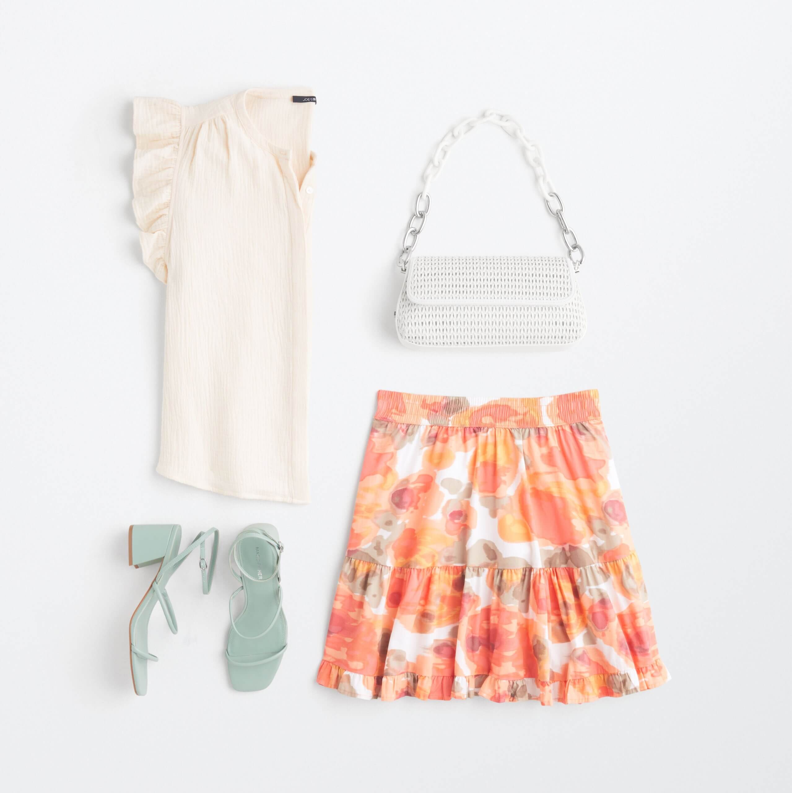 Stitch Fix women’s miniskirt outfit featuring floral skirt, white ruffle detail blouse, white chain-strap purse and mint heels.