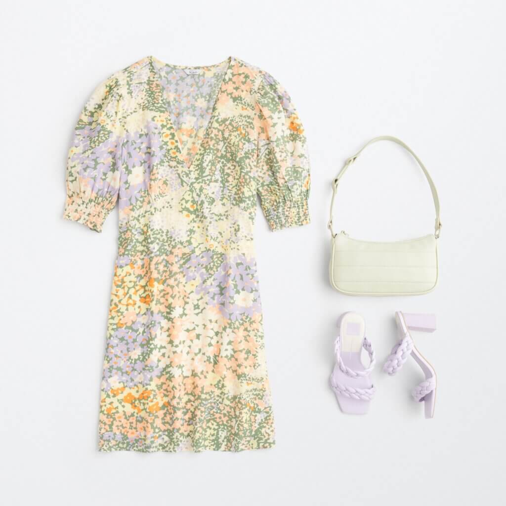 Stitch Fix women’s beach cocktail wedding attire with floral puff-sleeve dress, light yellow bag and lilac braided heels.