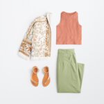 Stitch Fix women's 90s fashion outfit with burnt orange tank top, white boho print jacket, green pants and metallic sandals.