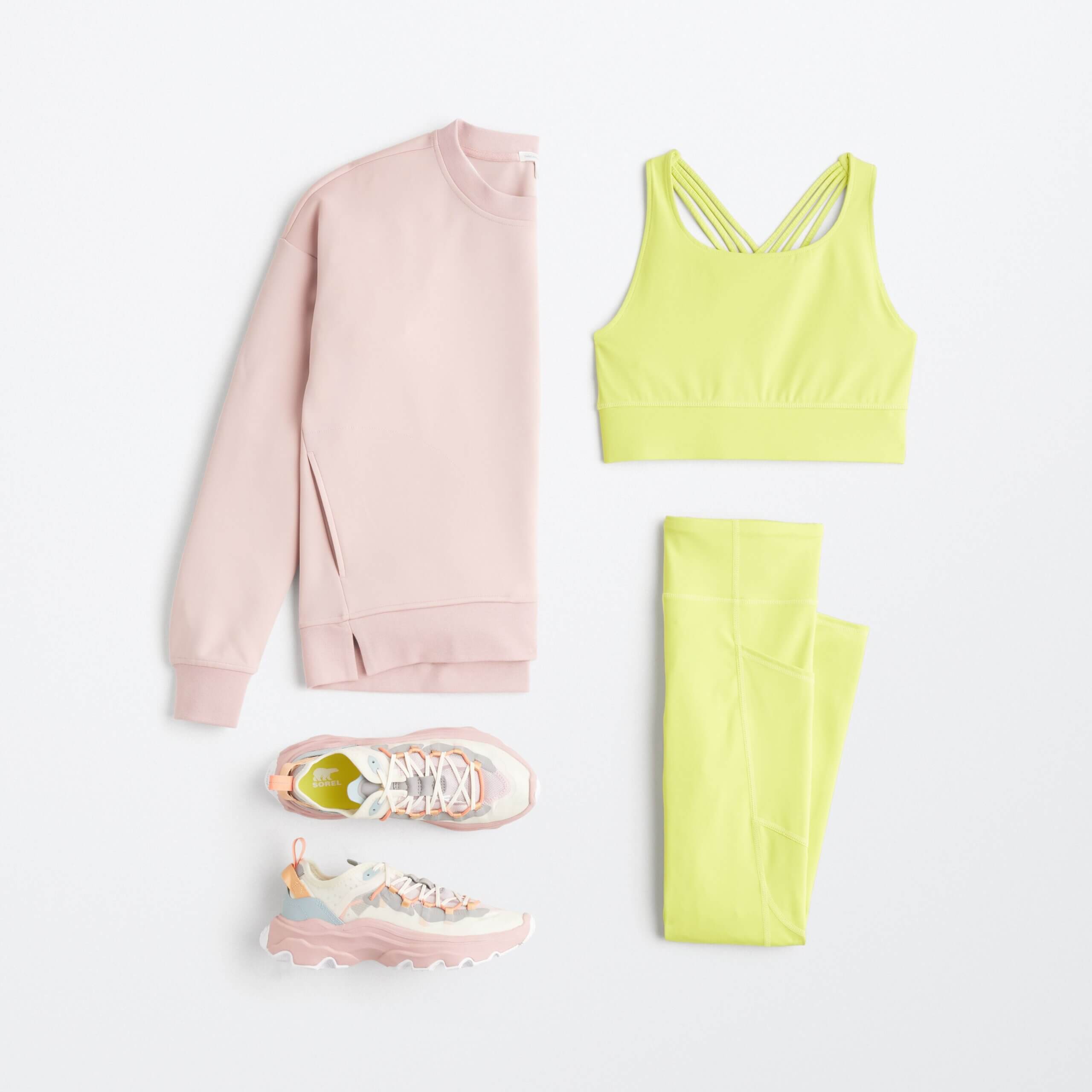 Stitch Fix women’s tennis outfit including a pink sweatshirt, yellow sports bra, yellow leggings and pink sneakers.