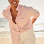 Stitch Fix model wearing women’s coastal grandmother outfit with white shorts and blush collared button-down top.