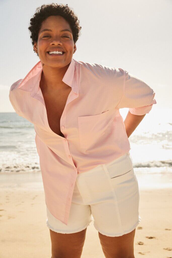 Stitch Fix model wearing women’s coastal grandmother outfit with white shorts and blush collared button-down top.