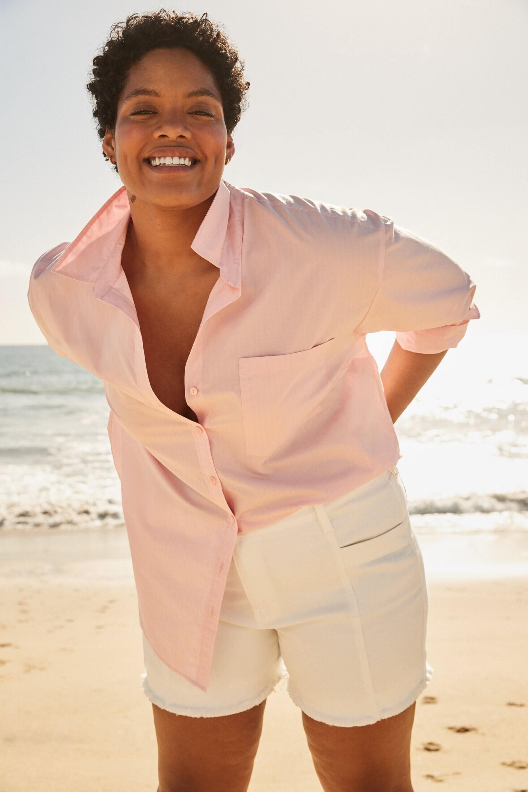 Stitch Fix model wearing women’s coastal grandmother outfit with white shorts and blush collared button-down top.