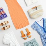 Stitch Fix women's picnic outfit featuring yellow blouse, green shorts, black and white tote hanging on rack and brown sandals on stool.