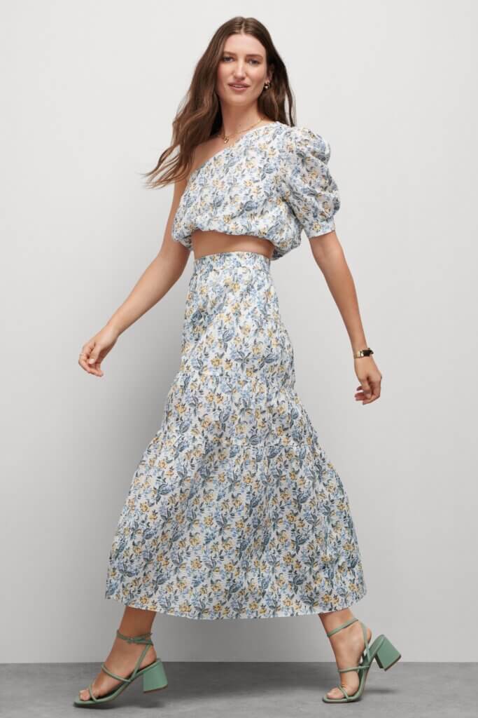 Stitch Fix model wearing women’s regencycore outfit featuring matching printed skirt and crop top with green block heel sandals.