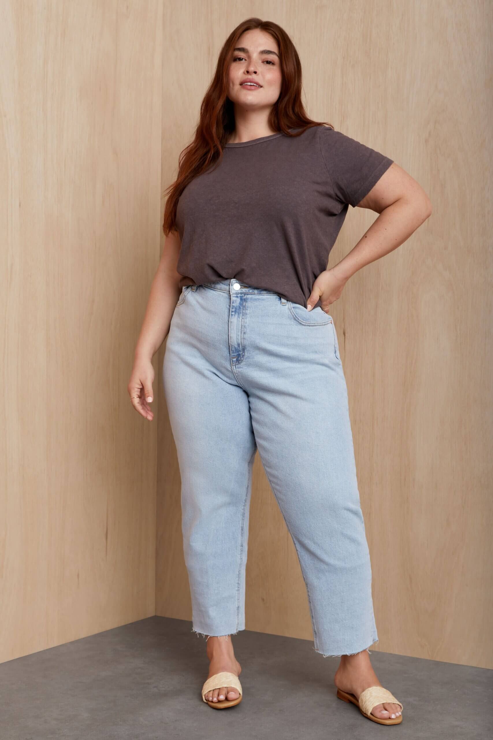 Stitch Fix model wearing women’s coastal grandmother outfit with light blue jeans, grey T-shirt and white sandals.
