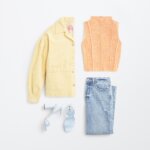 Stitch Fix women's Y2K fashion outfit with yellow jacket, orange sleeveless knit top, blue jeans and blue strappy heels.
