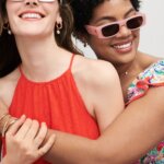 Two Stitch Fix models wearing women’s coastal grandmother outfits with red dress, floral dress and sunglasses.