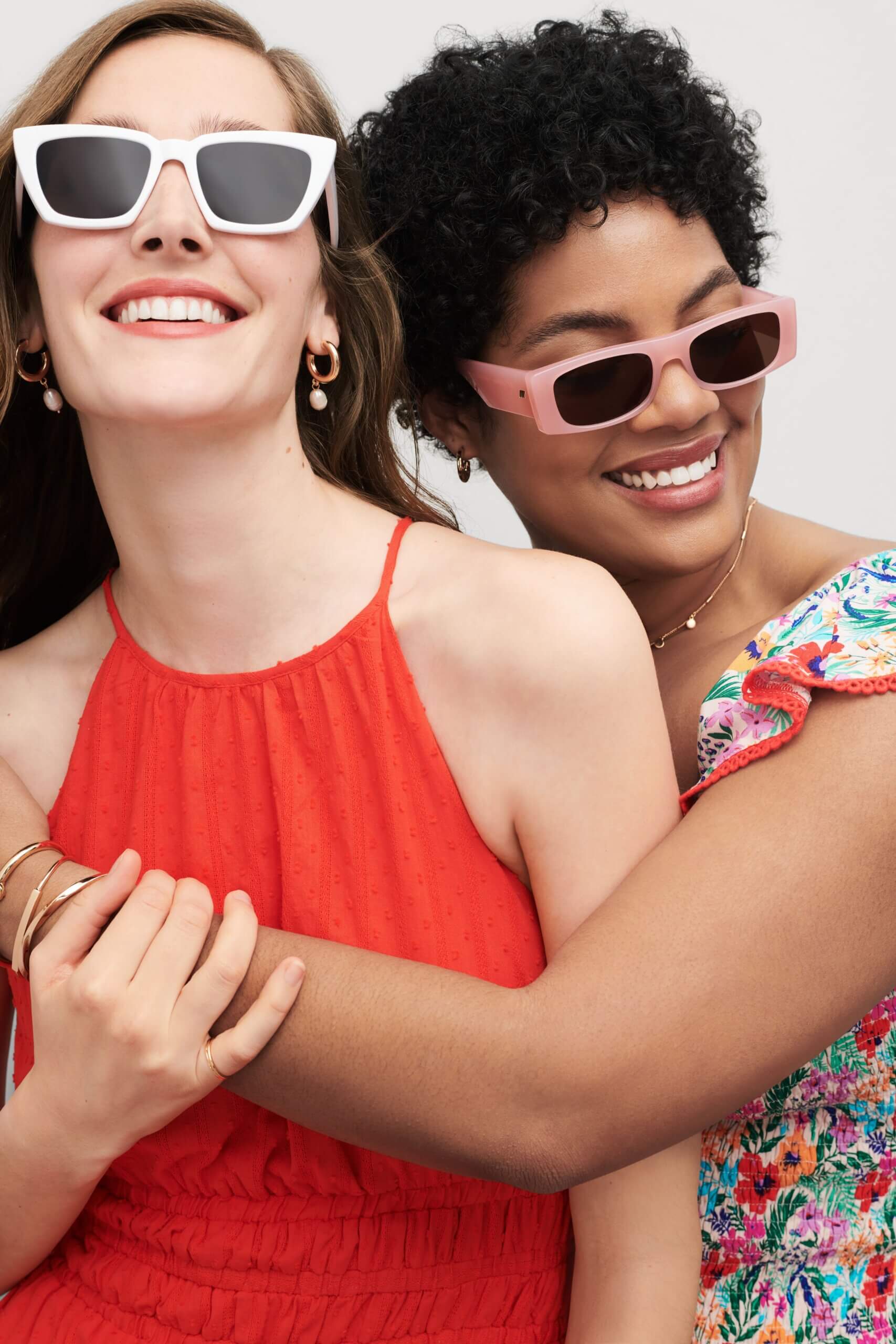 Two Stitch Fix models wearing women’s coastal grandmother outfits with red dress, floral dress and sunglasses.