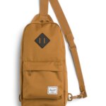 Stitch Fix women’s essential road trip packing list burnt orange cross shoulder backpack.