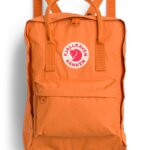Stitch Fix women’s essential road trip packing list safety orange backpack with white and red brand logo.