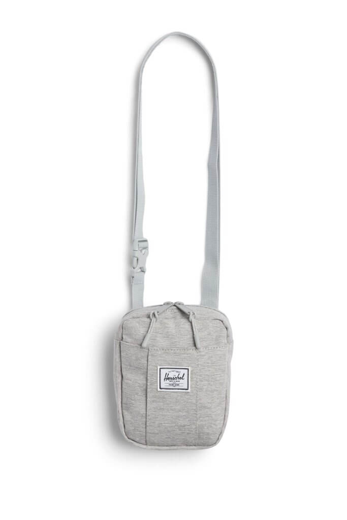 Stitch Fix women’s essential road trip packing list heather grey cross body bag with white and black brand logo.