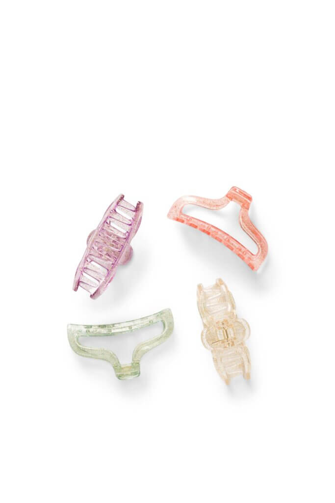 Stitch Fix women’s set of four purple, pink, green and yellow glitter plastic hair clips.