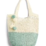 Stitch Fix women’s off-white and mint-green tote bag with pom-poms.