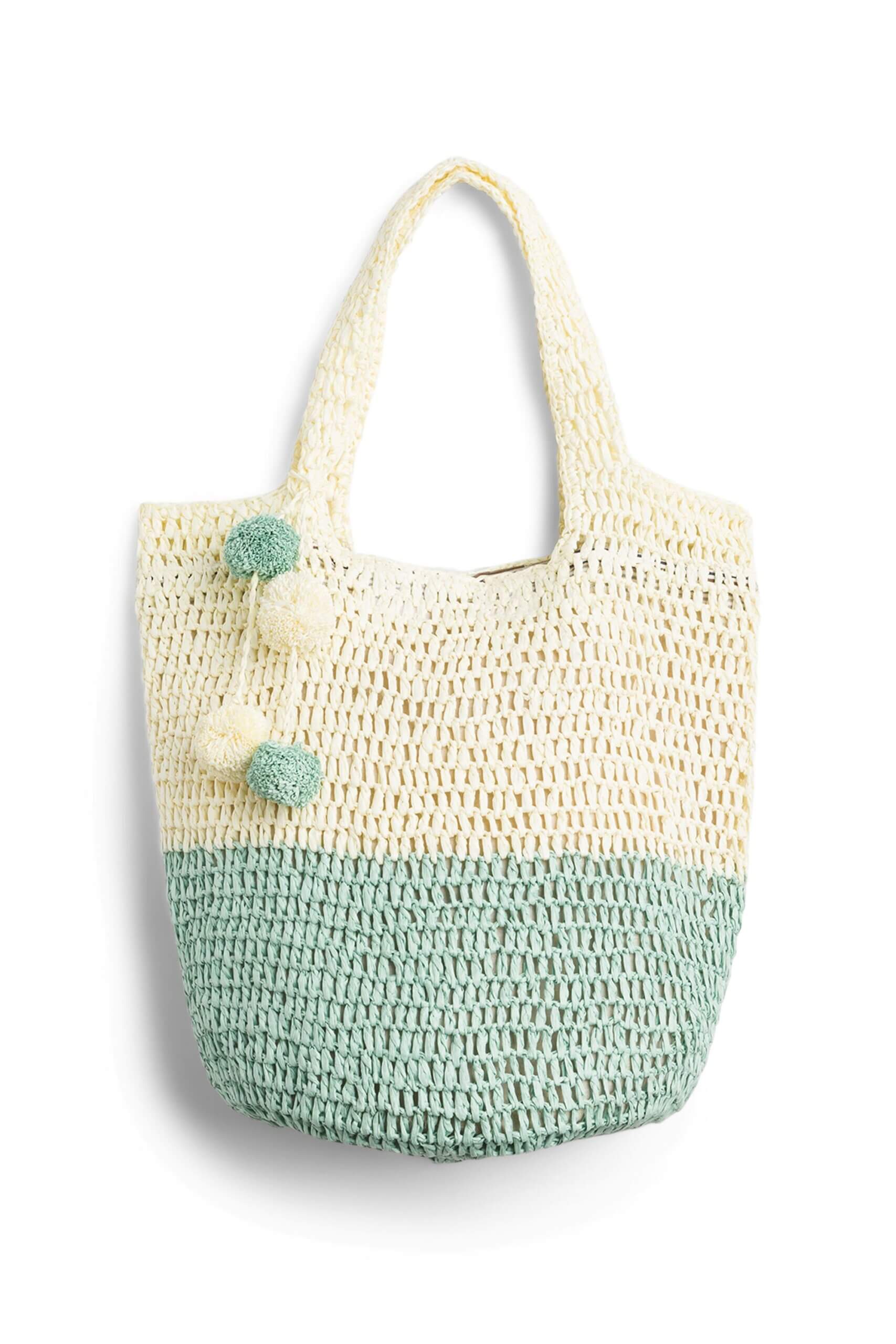 Stitch Fix women’s off-white and mint-green tote bag with pom-poms.