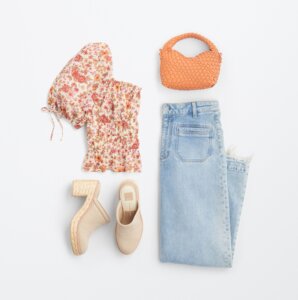 travel outfit for women with jeans, clogs, and floral print top