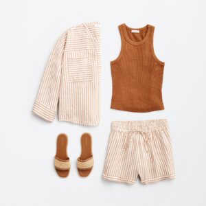 beach vacation outfit with brown top, jacket, sandals, and shorts