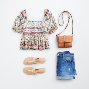 concert outfit with jean shorts, sandals, purse, and ruffled top