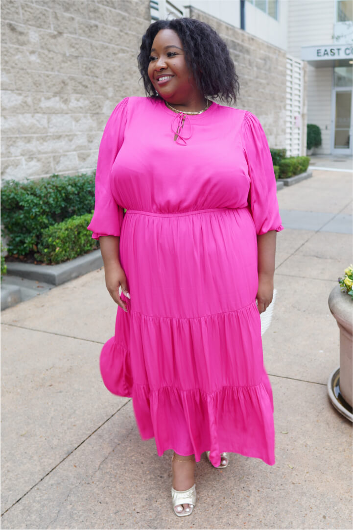 woman with oval shape body wearing monochrome outfit including pink dress