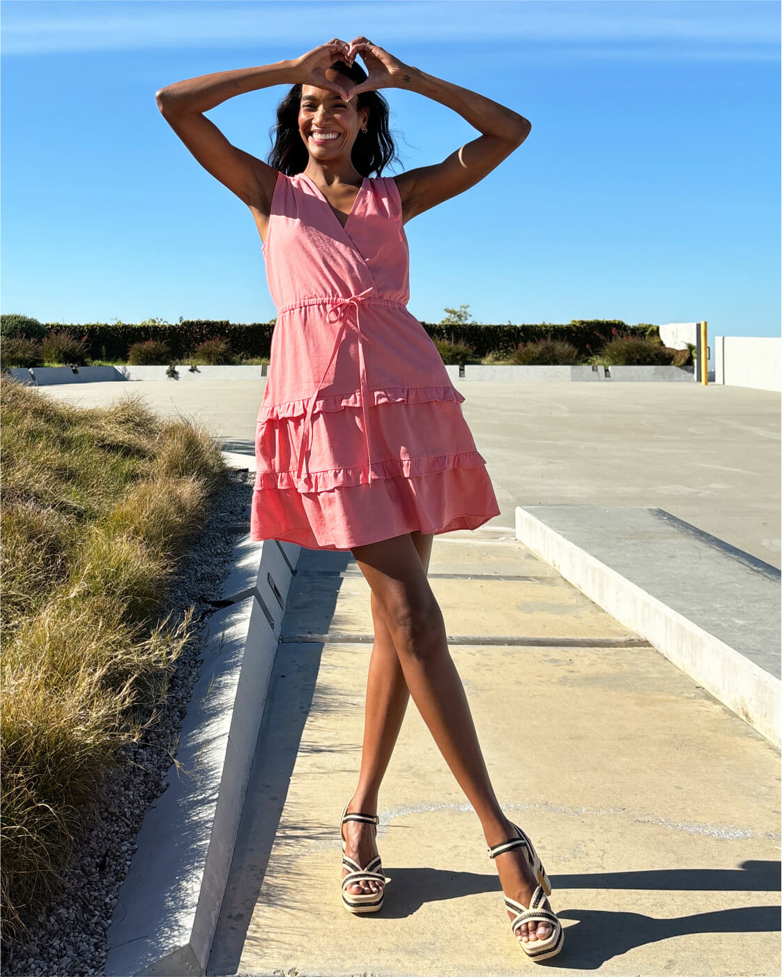 woman in pink dress with triangle body shape